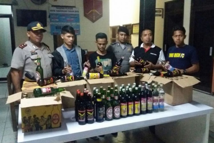 Tangerang City Police in Banten show confiscated alcoholic drinks after raiding jamu (herbal drink) stalls suspected of selling bootleg liquor on April 4.