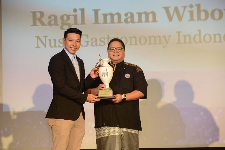 Ragil Imam Wibowo of Nusa Indonesian Gastronomy receives the award of excellence at the World Gourmet Summit 2018.