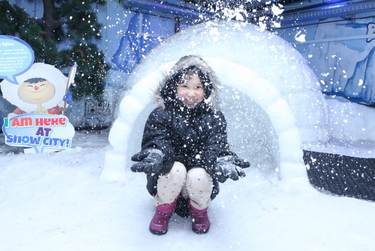 A child playing in Snow City, Science Centre Singapore.