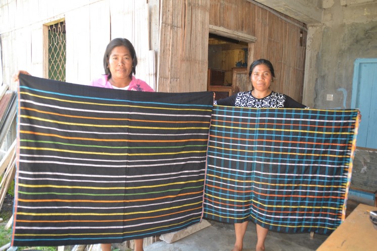 Women in East Manggarai, Flores, display 'congkar' woven fabrics.