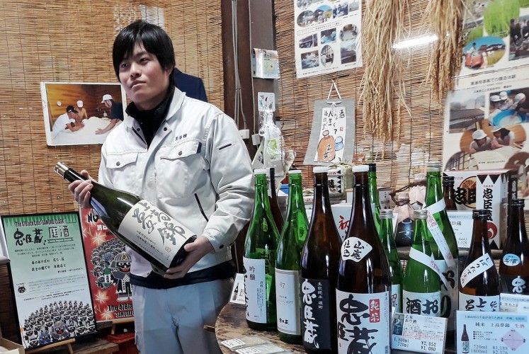 Sake master: Okuto Kan, the owner of the 400-year-old Okuto sake brewery, shows a bottle of sake in Oku City. The traditional brewery produces 20,000 liters of sake per year.