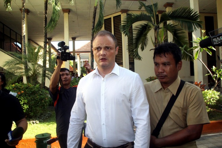 Awaiting fate: Roberts is escorted to a courtroom at the Denpasar District Court on Wednesday.