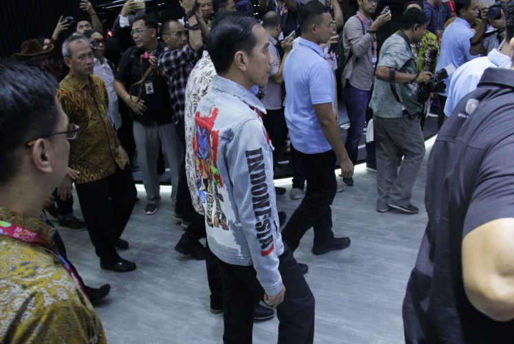 Looking stylish: President Joko Widodo wears a denim jacket with a map of Indonesia emblazoned across the chest. 