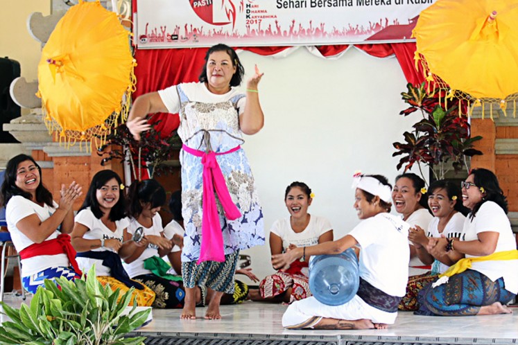 In joy and happiness: A female prisoner performs a Balinese traditional dance during Correctional Day celebrations at Bangli prison on April 25. 