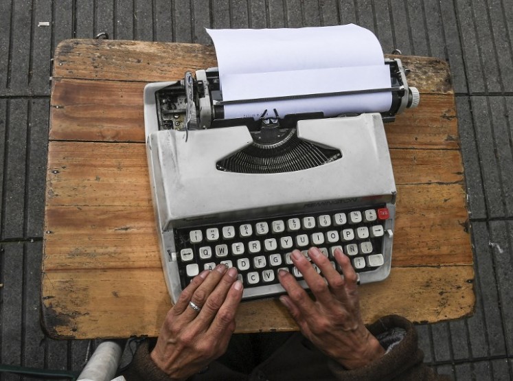 Street clerk Candelaria Pinilla,63, types a letter on her typewriter, in front of the district taxing office in Bogota, on April 9, 2018 Street clerks are experts in filling out forms, documents and even in typing letters, to help their clients with paperwork. 
