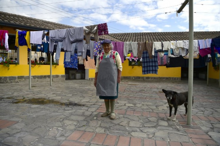 Ecuadorean washerwoman Delia Veloz, 74, is pictured next to clothes hang-drying at the municipal laundry of the Ermita neighborhood, in Quito, on March 5, 2018. Veloz has been a washerwoman for over 50 years and earns around four dollars a day.