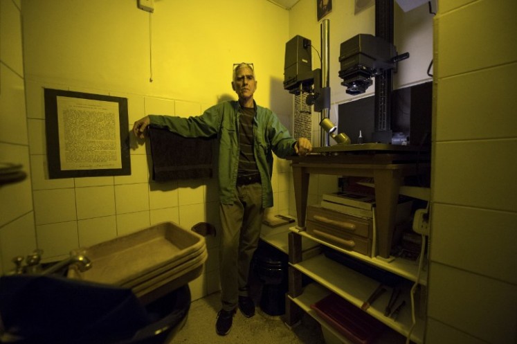 Rodrigo Benavides a 58-year-old Venezuelan darkroom technician poses for a picture at his darkroom in Caracas on April 19, 2018. 