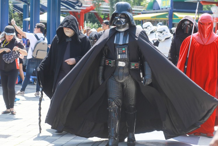 Star Wars characters walk down the street during Lego Star Wars Days's Imperial March.