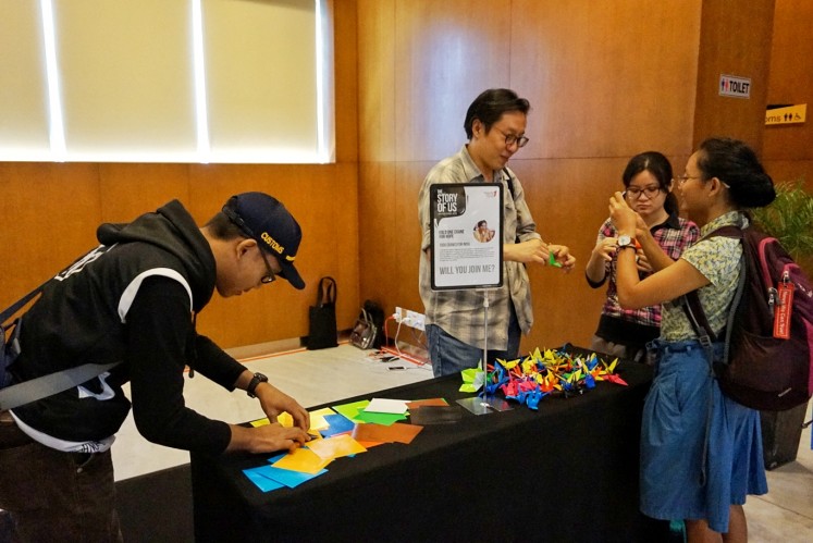 Participants fold paper cranes in a provided space at the Writers' Series event in Central Jakarta on May 5. 