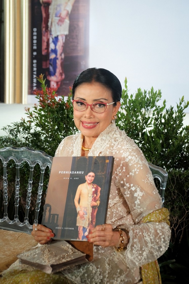 Mien R Uno poses with her new book, 'Perhiasanku'. 