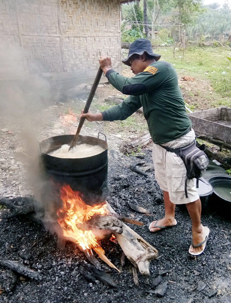 Hot meal: Mahout Katiyo prepares porridge for his elephants.