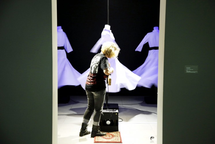War on war: An installation transforms an AK-47 assault rifle into a guitar, aiming it at Middle Eastern-inspired garb.