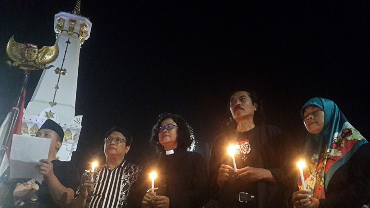 Hundreds of Yogyakarta residents of various religious, professional and ethnic backgrounds gather at Tugu Monument, Yogyakarta, to pray for and show solidarity to victims of suicide bombings in three churches in Surabaya, East Java, on May 13. 