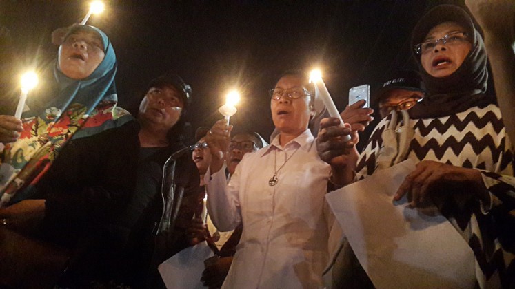 Remembrance: Yogyakarta residents and religious leaders attend a candlelight vigil at Tugu Monument, Yogyakarta, following suicide bombings in Surabaya, East Java, on May 13.

