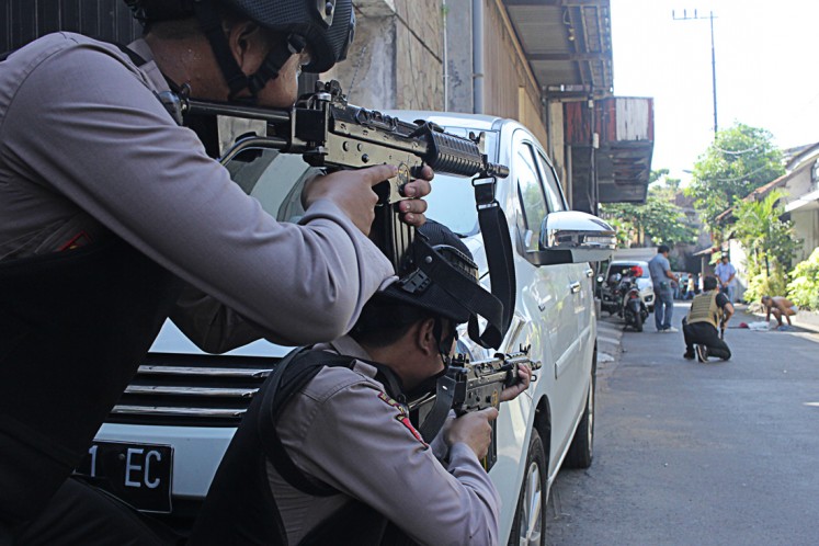 On alert: Police officers stand guard in areas around Jl. Niaga Samping following a bomb blast at the Surabaya Police headquarters in Surabaya, East Java, on May 14.  