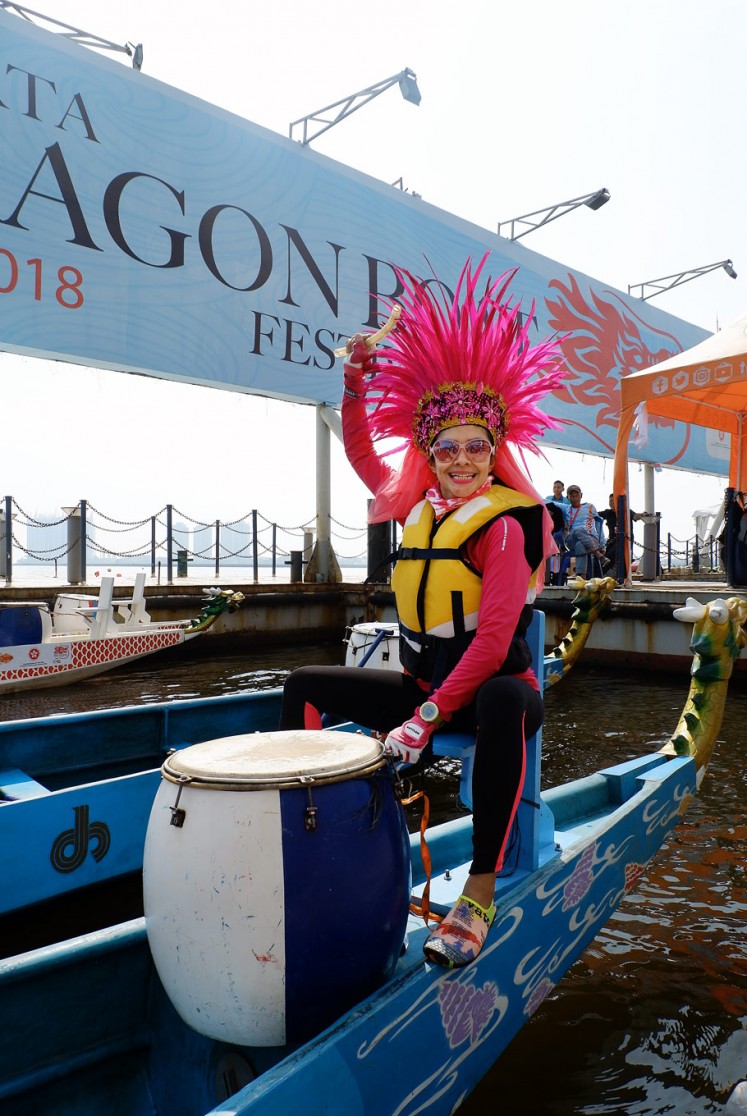 Let’s rock: The captain of a dragon boat team wears an eye-catching pink feather headdress.