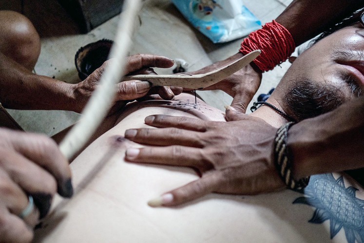 Tattoo: Mentawai tribesmen demonstrate the traditional art of tattoo.