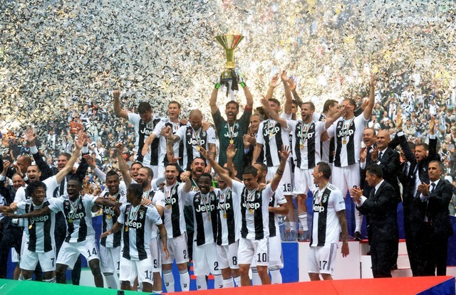 Juventus' Gianluigi Buffon lifts the trophy as the Juventus players celebrate winning the league. 