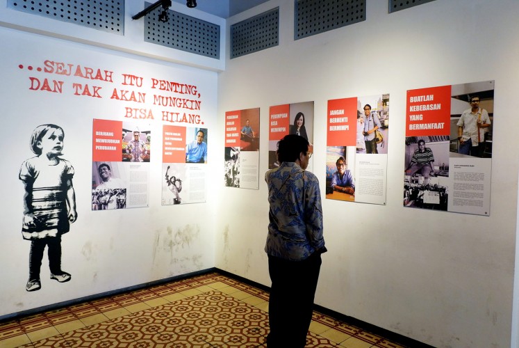 Now and then: A visitor looks at photos of 1998 activists at Antara Photojournalism Gallery in Jakarta.