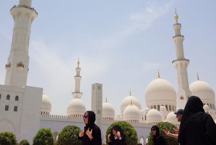Transcendental: Visitors walk through the Sheikh Zayed Grand Mosque compound.