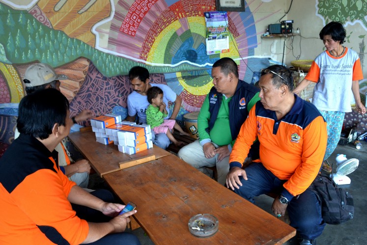 Sukiman Mohtar Pratomo (in grey shirt) is the head of the radio station. He can be seen here coordinating with the Magelang Disaster Mitigation Agency on the latest updates on Mount Merapi eruptions.