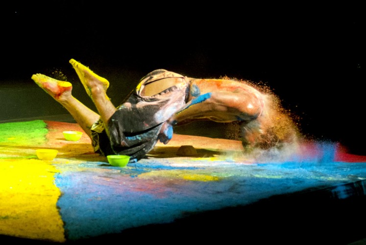 Crashing: The dancer uses bright-colored powder as part of his performance.