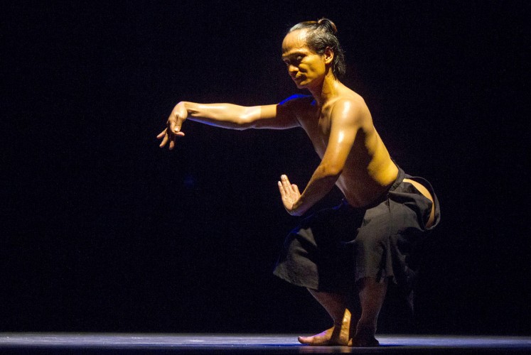 In the dark: Riyanto combines modern and traditional dance movements, as well as masculine and feminine gestures in his dance.