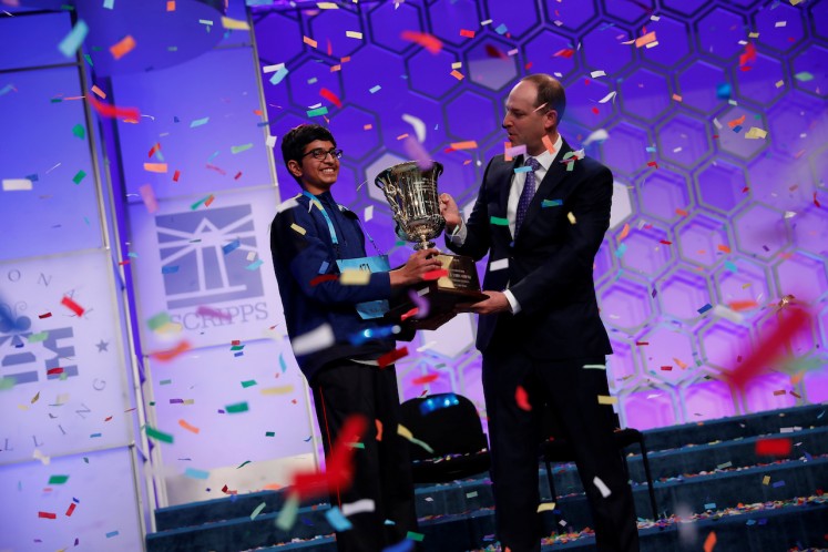 Karthik Nemmani celebrates with E.W. Scripps Company CEO Adam Symson after winning the Scripps National Spelling Bee at National Harbor in Oxon Hill, Maryland, U.S., May 31, 2018.