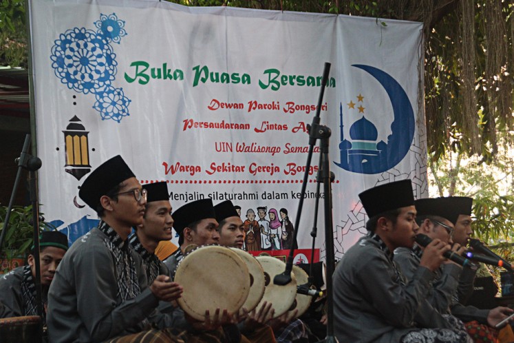 Togetherness: Members of Jami'atul Quro wal Huffadh, a rebana (traditional tambourine) musical group, sing Islamic songs during a breaking-of-the fast event held by the St.Theresia Bongsari Church in Semarang, Central Java, on June 1.