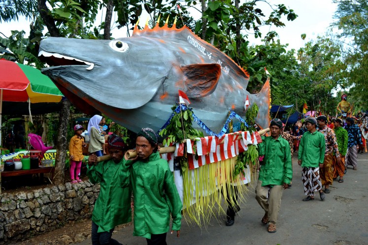 One of Jumiyo's papier m'ché sculptures are featured in a village ceremony  to celebrate the harvest. 