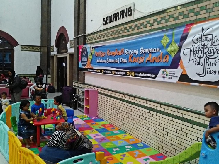 Happy time: Children play in a playing ground provided by state railway company KAI Operational Region (Daop) IV Semarang for travellers at Tawang Station in Semarang, Central Java, on June 12. 