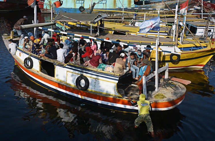 Joyful day: Gili Ketapang residents get ready to travel to Probolinggo city, East Java, to shop for goods for their Idul Fitri celebration.