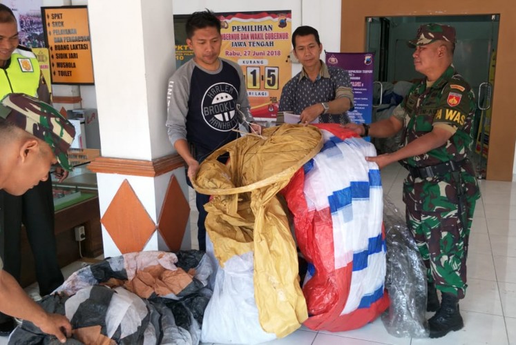 Local authorities secure hot air balloons that are set to be released in Wonosobo regency, Central Java, on Saturday, June 16. 