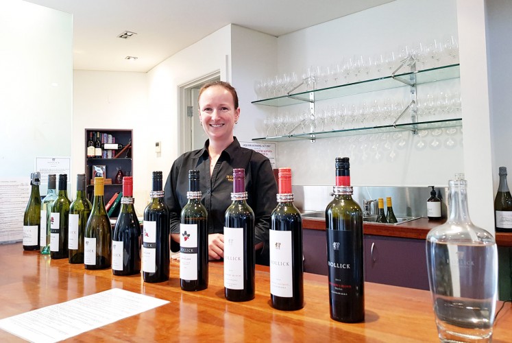 Pick your favorite: A cellar door assistant shows a selection of wines for tasting by Hollick Estates.