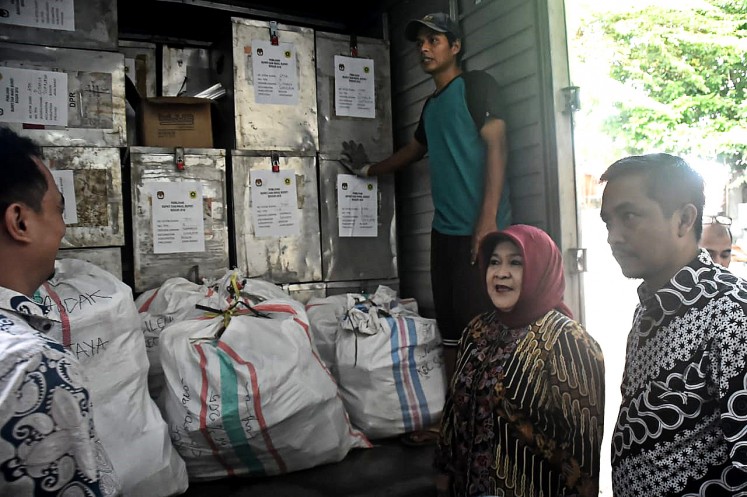All set: Bogor Regent Nurhayanti (center) checks ballot papers and boxes that will be distributed in 27 districts across the regency ahead of the Bogor regental election and the West Java provincial election slated for June 27. 