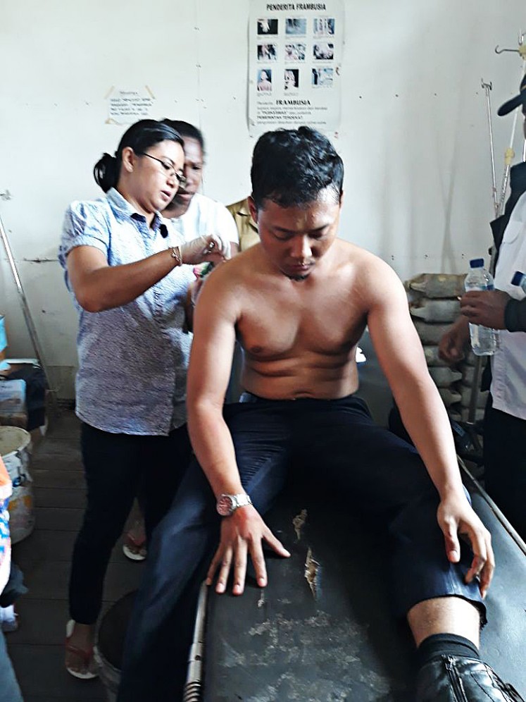 Pilot Ahmad Abdillah Kamil, 27, receives medical treatment at the Kenyam health clinic in Nduga, Papua, after suffering gunshot wounds to his left back in a shooting incident on June 25. The Twin Otter aircraft he piloted from Wamena Airport, Jayawijaya, was fired on shortly after it landed at Kenyam Nduga Airport. 