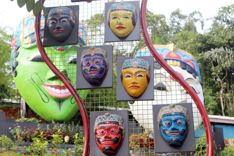 Many faces: Small masks are put on display in front of Panji Asmara Bangun and his wife Dewi Sekartaji in Kampung Topeng.