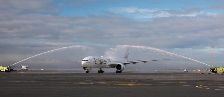 The inaugural flight is greeted with a water salute at the Auckland airport.