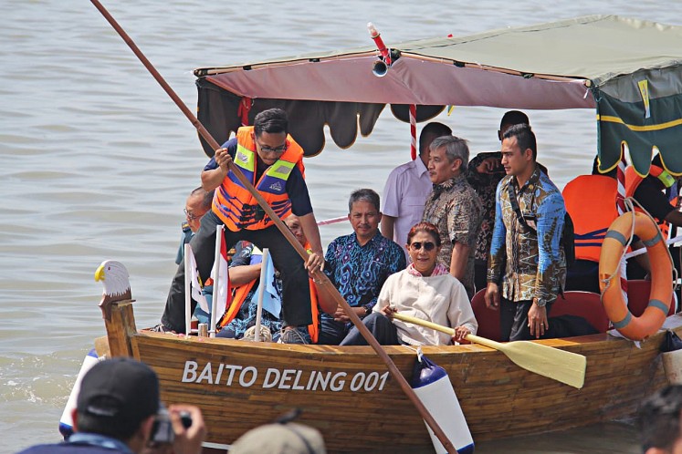 Affordable fishing: Maritime Affairs and Fisheries Minister Susi Pudjiastuti rides the world’s first bamboo vessel after it was officially launched at an event at Kenjeran Beach in Surabaya, East Java, on July 2. The vessel is expected to provide fishermen with a more affordable option.