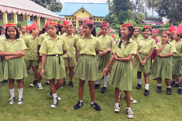 Pride of the tribe: Schoolchildren wear traditional headbands.