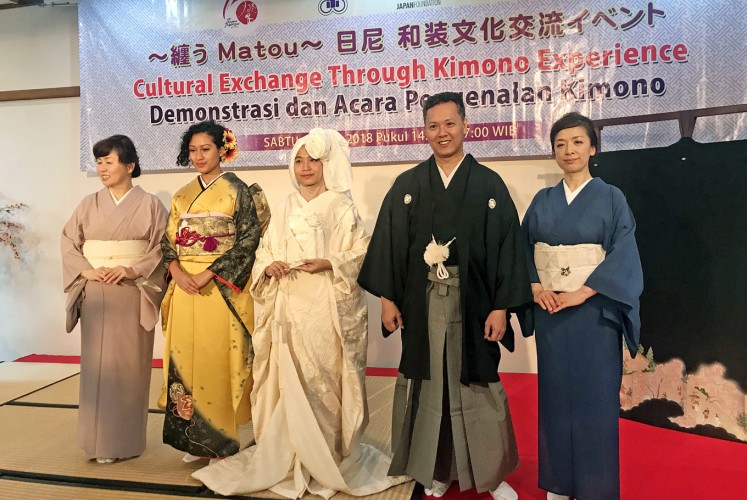 Iconic attire: Yuko Nakano (far right) and Miyuki Ishii (far left) pose with three matou (kimono demonstration) participants who are wearing a long-sleeved furisode (second left), a hanayome kimono for brides (center) and a male kimono, montsuki hakama.