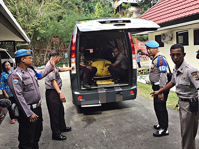 Fatal attack: Personnel remove the body of Brig. Sinton Kbarek from a vehicle for an autopsy at Bhayangkara Hospital in Jayapura, Papua. Sinton's body was found four days after he was reported missing on June 27. Sinton was buried in Jayapura on July 3.