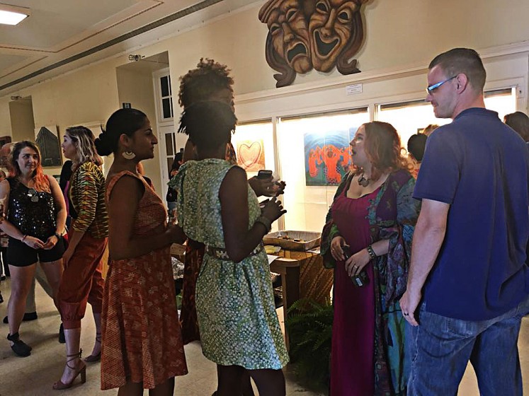 Viewing beauty: Visitors are photographed during Saturday's opening reception for Srikandi 5's month-long “Beautiful Indonesian Arts and Paintings Exhibition” at the Niagara Arts & Cultural Center (NACC) in New York state.