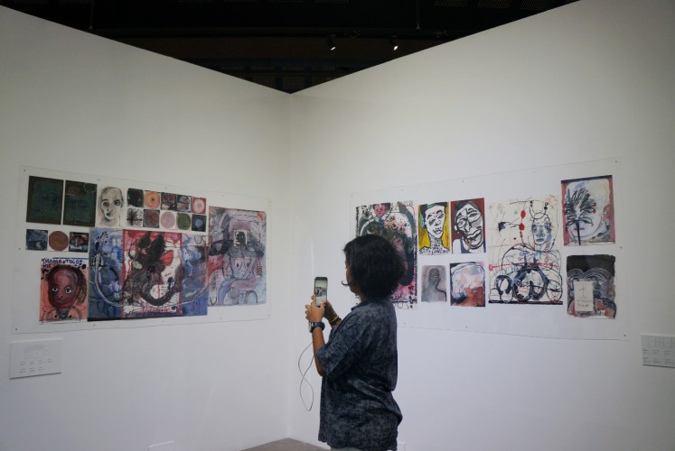 A visitor takes a photo of artist Natisa Jones' work. 