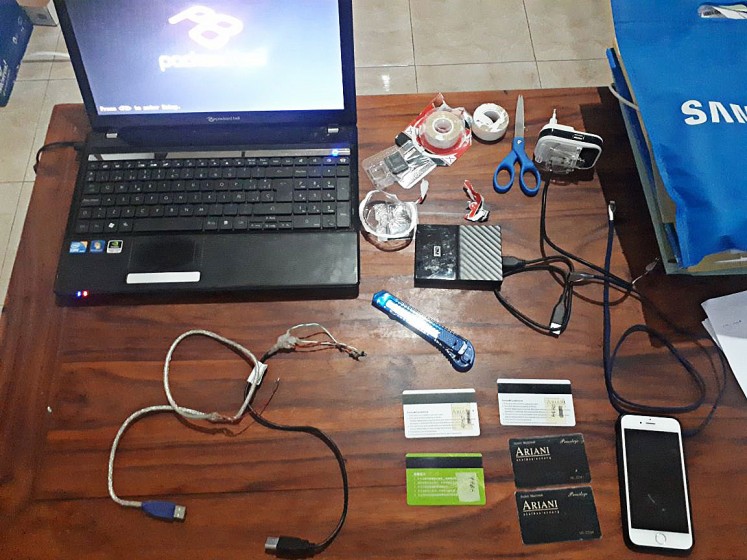 The Klungkung Police display evidence confiscated from two foreigners allegedly committing ATM data scamming in Klungkung, Bali, on July 9. p