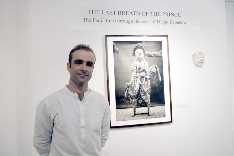 Captivated by Panji: Spanish photographer Diego Zapataro poses with one of his photographs currently being exhibited at the National Gallery.