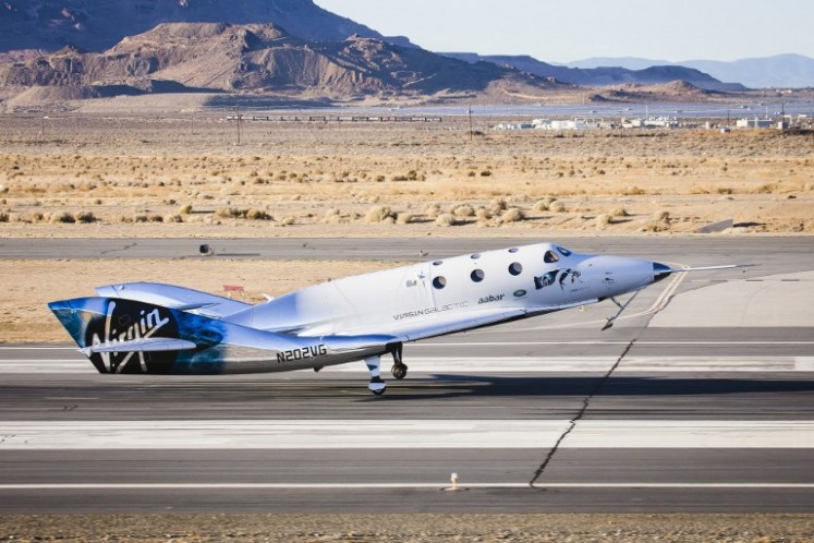 This December 3, 2016 handout photograph obtained courtesy of Virgin Galactic shows the Virgin Spaceship (VSS) Unity as it touches down after flying freely for the first time after being released from Virgin Mothership Eve (VMS Eve) in the Mojave Desert, California. 