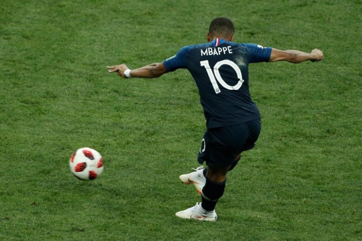 France's forward Kylian Mbappe shoots and scores a goal during the Russia 2018 World Cup final football match between France and Croatia at the Luzhniki Stadium in Moscow on July 15, 2018. 