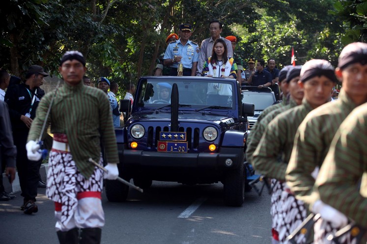 Yogyakarta residents hold a parade to celebrate the arrival of the Asian Games torch on July 17. 
