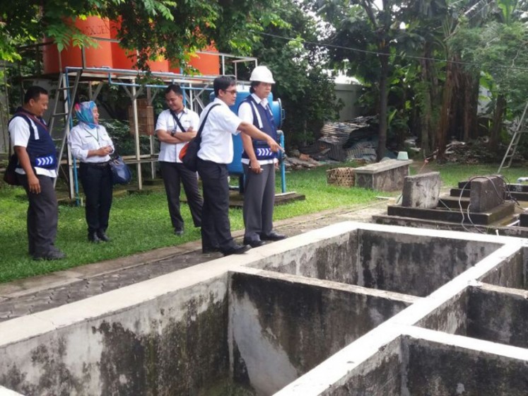 Officials from the city administration and city-owned wastewater management firm PD PAL Jaya inspect a communal wastewater treatment site in Malakasari, East Jakarta, in 2017. 